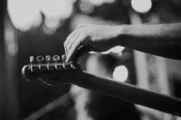 Nahaufnahme einer Hand beim Stimmen einer E-Gitarre 